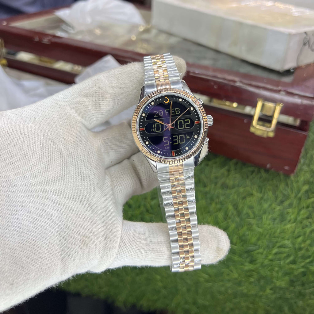 Gold and silver watch held by a gloved 