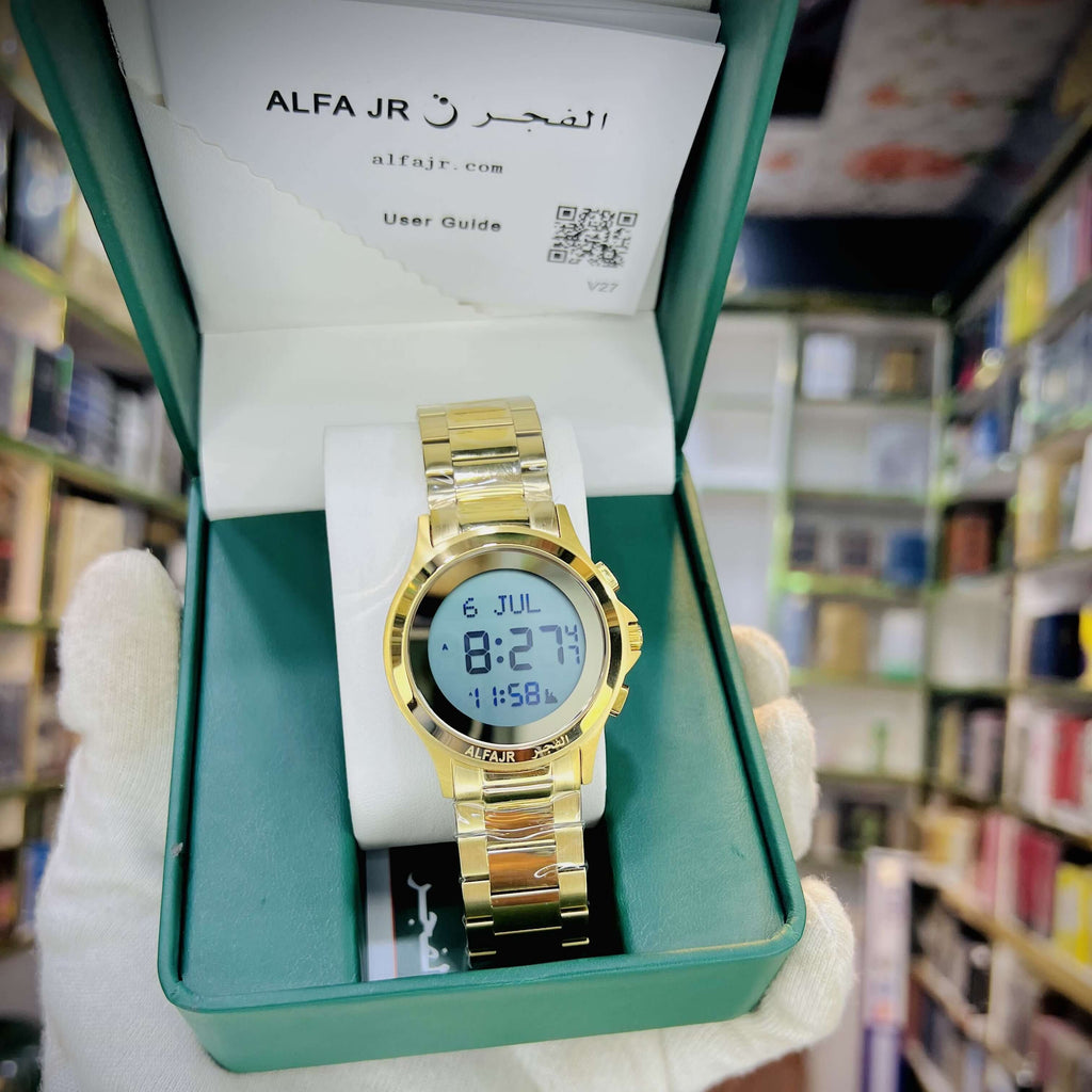Gold digital watch in a green box, held by a gloved hand in a bookstore.