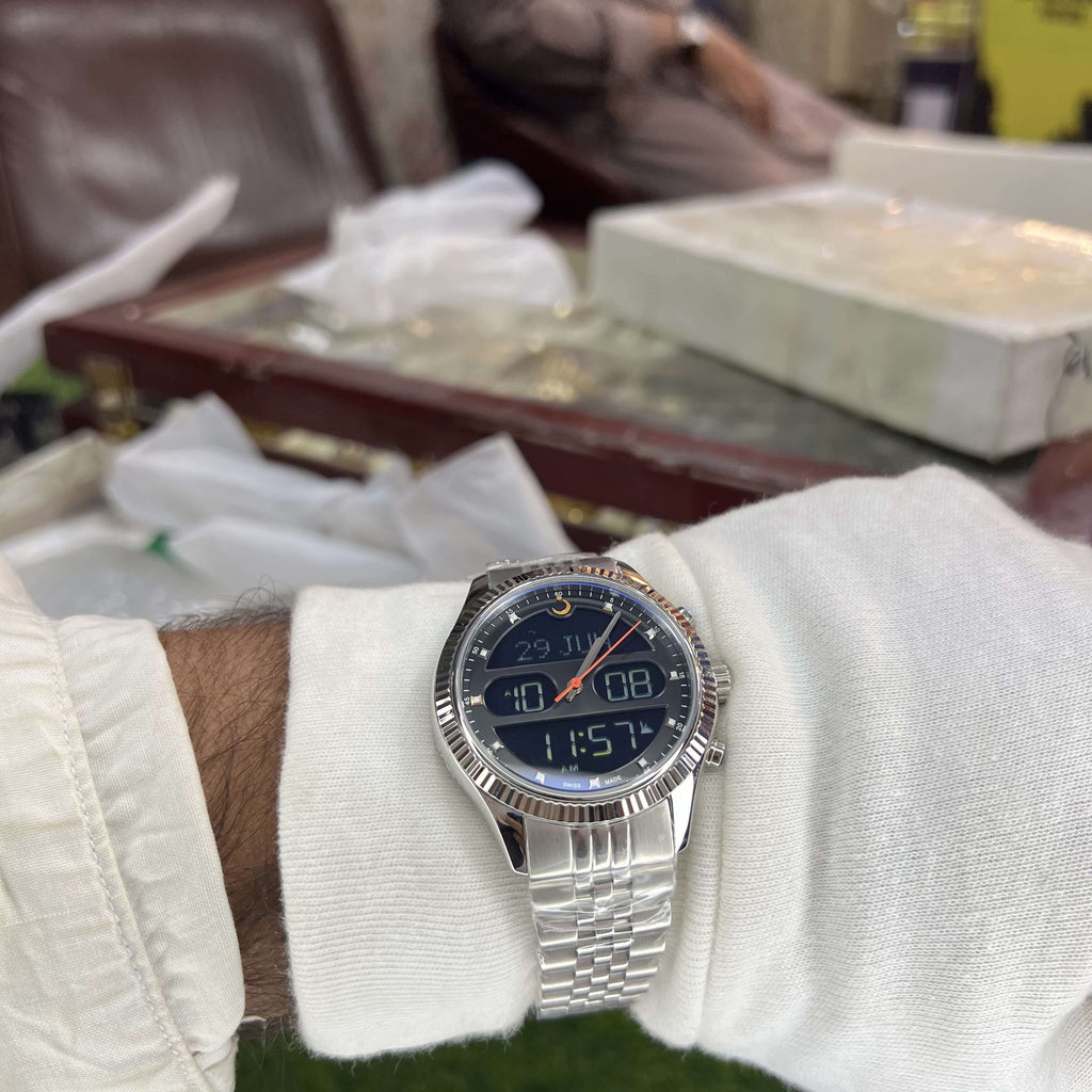 Silver watch on a wrist with a blurred indoor background