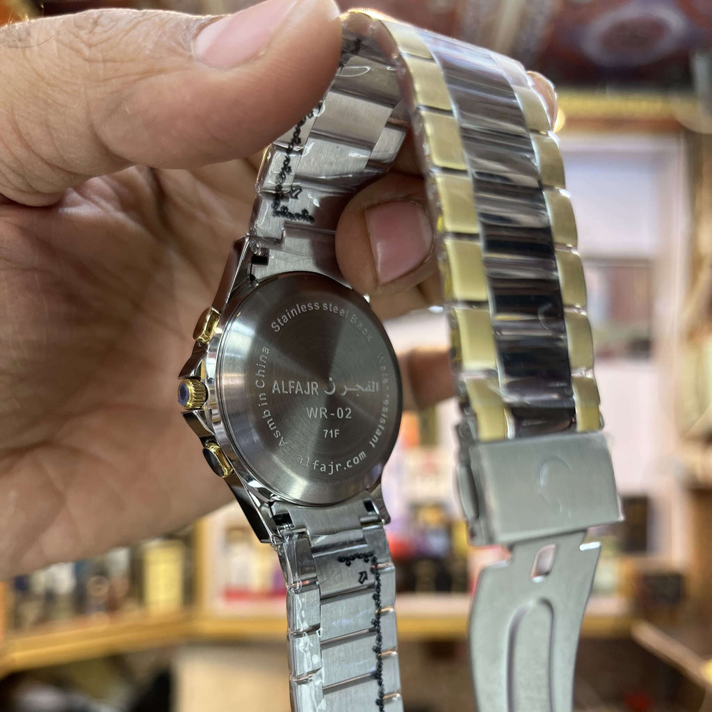 Silver watch with a detailed band held by a hand 