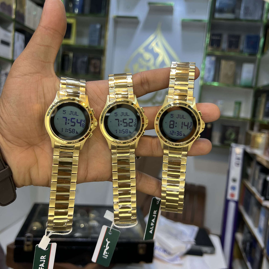 Three gold digital watches held in a hand with a blurred background